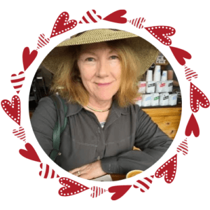 Woman wearing a hat, surrounded by a graphic wreath of hearts
