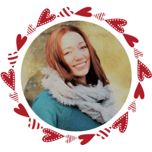woman in a blue sweater, with a scarf wrapped around her neck