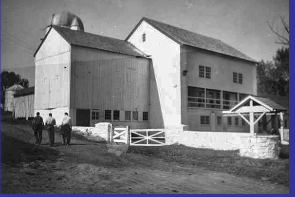 black and white photo shows angled view of completed party barn