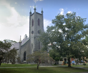 St. James Place limestone Gothic Revival style church with a tower