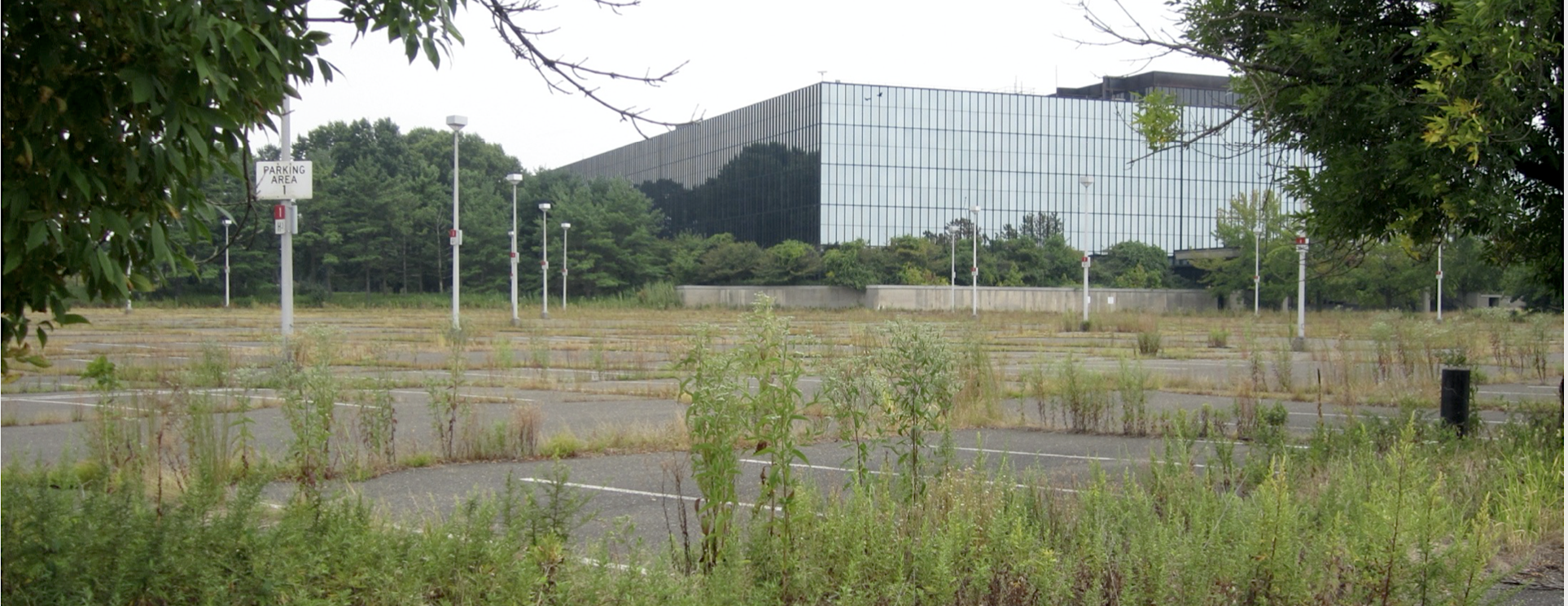 Vacant Bell Labs Holmdel building viewed across an empty parking lot