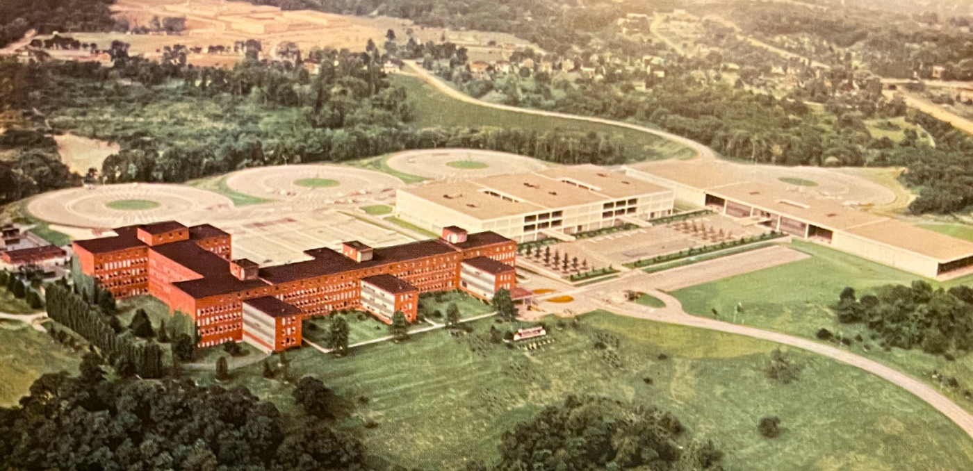 1962 color illustration shows the brick research buildings in the foreground, new buildings and circular parking lots behind
