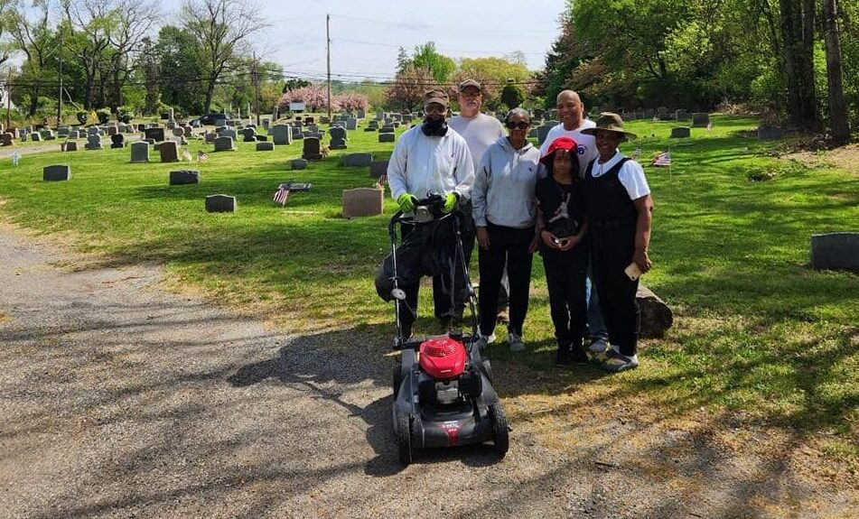 Volunteers cleaning up Green Lawn Cemetery in Delaware County on Earth Day 2023