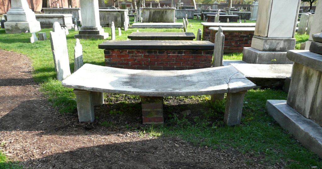 A gravestone slab bowing and flexing due to hysteresis at Christ Church Burial Ground