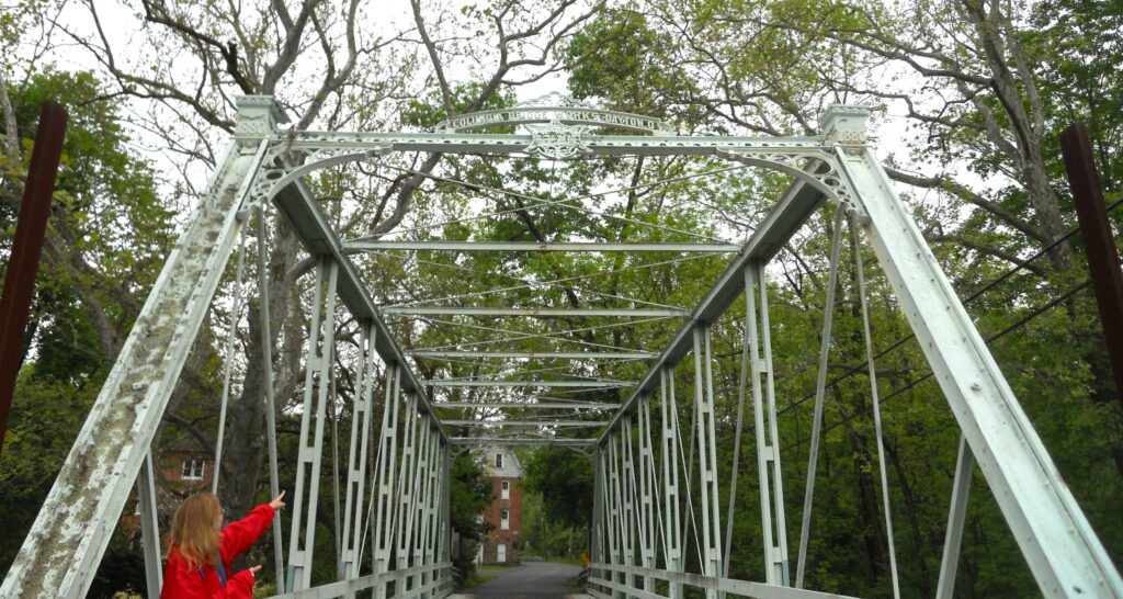 View from the entrance of the Peevy Road truss bridge showing decorative cast iron metalwork