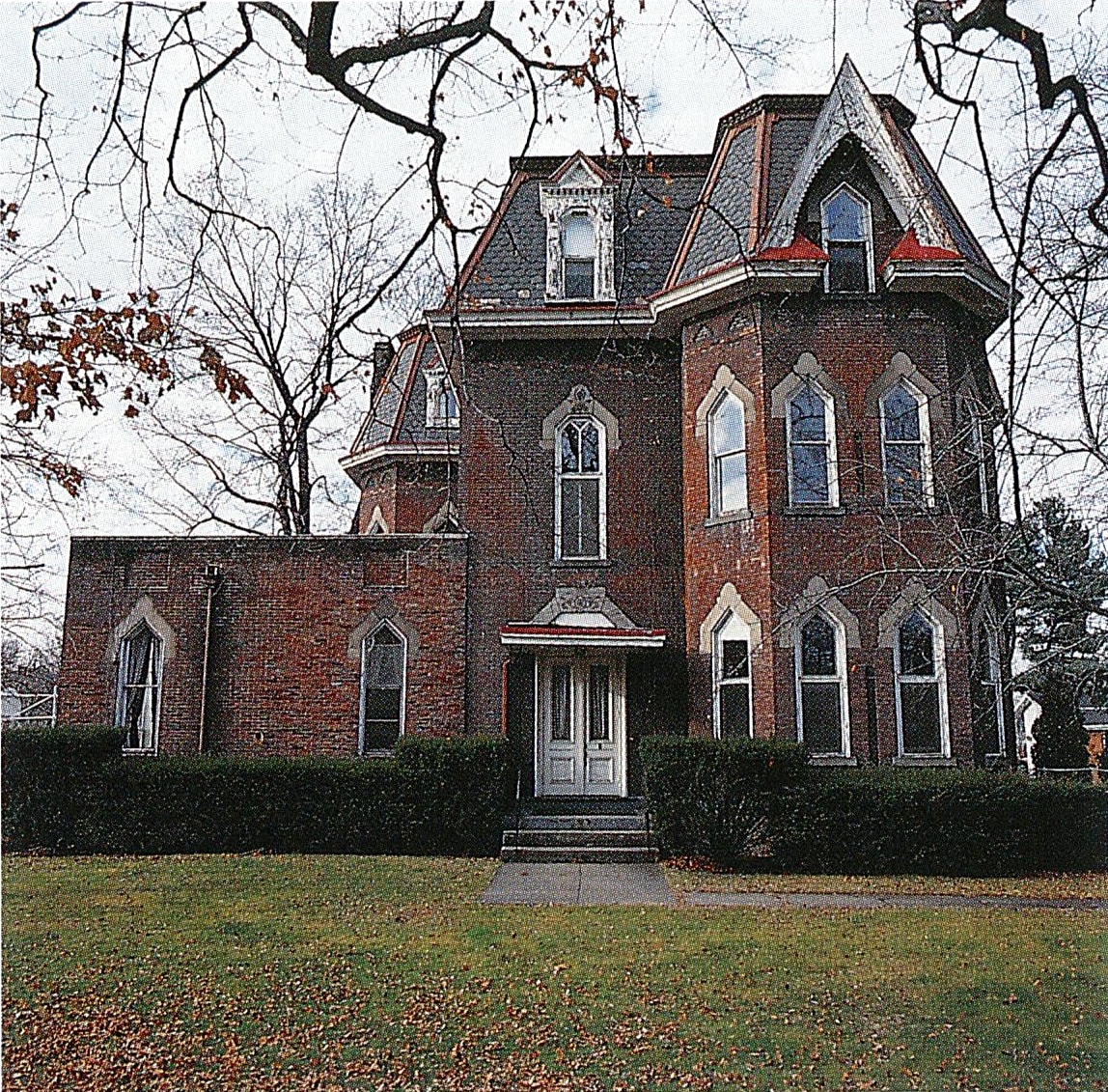 Exterior of the deteriorating D.C. Herbst House Victorian mansion in Sewickley, overgrown with vine