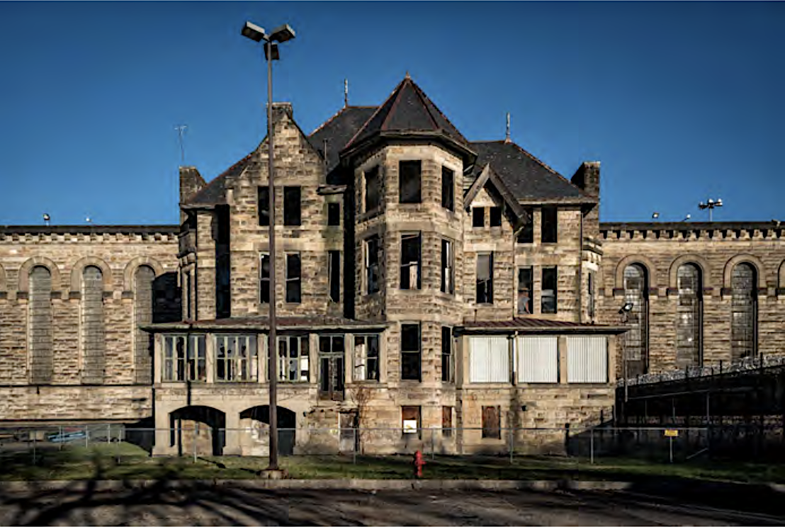 The Warden's House in front of the towering Western State Penitentiary walls along the Ohio River