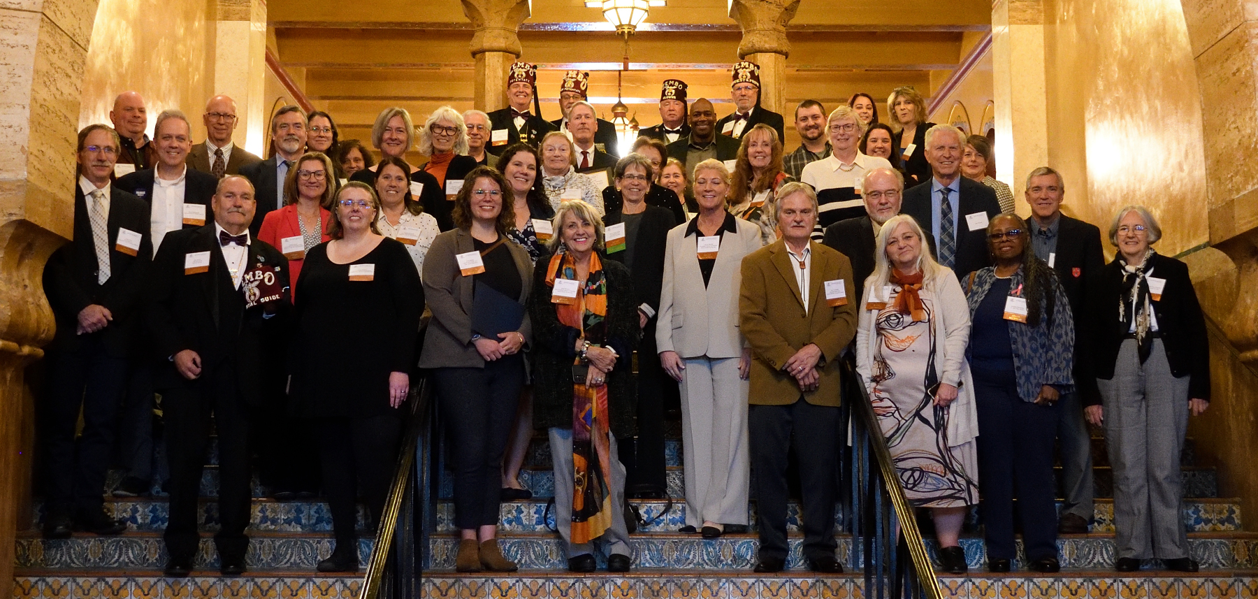 Group of 2024 PA Historic Preservation Award honorees on the decorative tile stairs of the Zembo Shrine