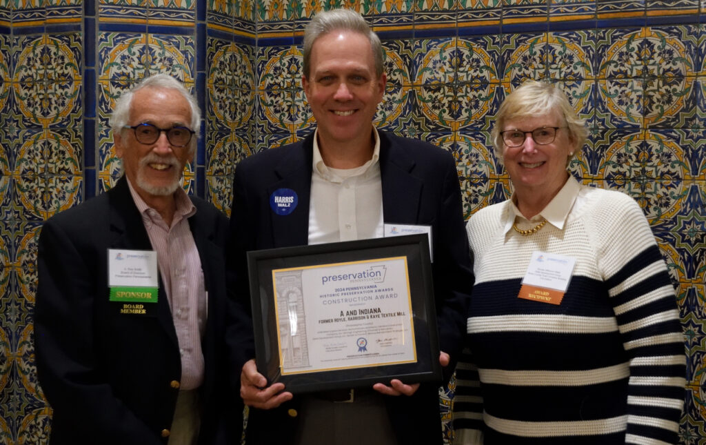 Roy Smith presenting the Rehabilitation Award to Bruce Adelsberger and Bonnie Wilkinson Mark for the A and Indiana textile mill project